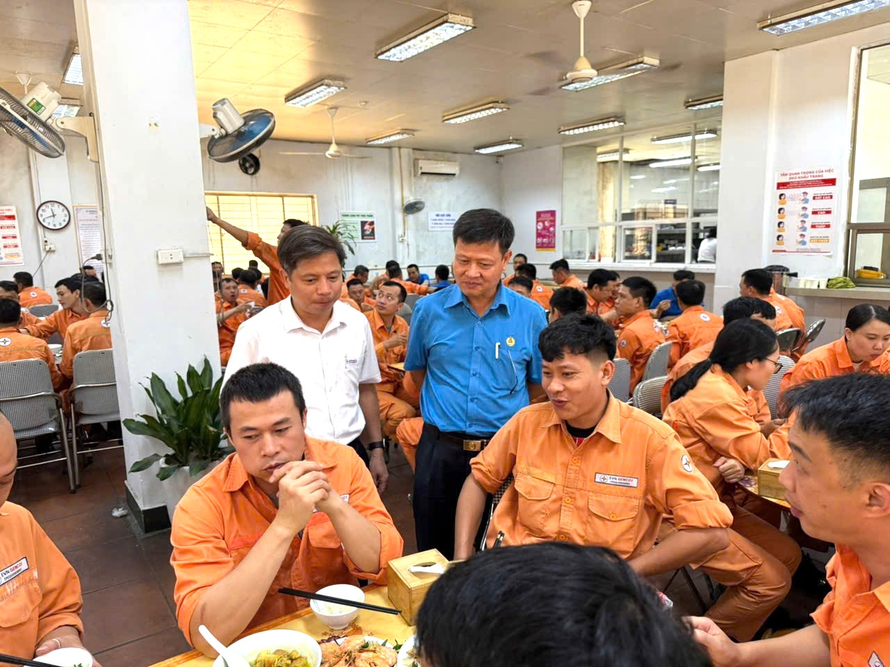 A group of people in orange shirtsAI-generated content may be incorrect.